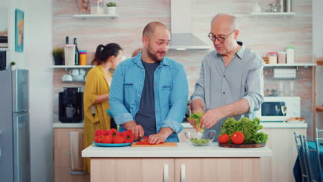 Grandfather-and-son-preparing-a-salad