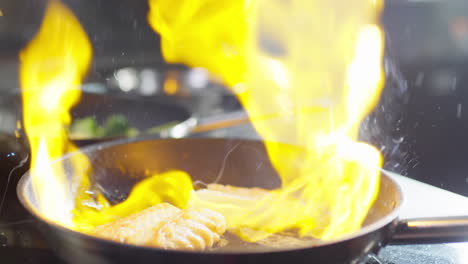 flambeing fish on skillet