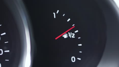 car fuel gauge showing low fuel level