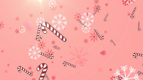 Animation-of-candy-canes-and-snow-falling-on-glowing-pink-background