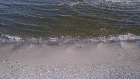 baltic sea waves roll over a sandy beach