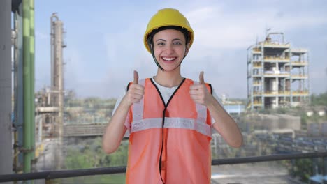 happy indian female construction worker doing thumbs up