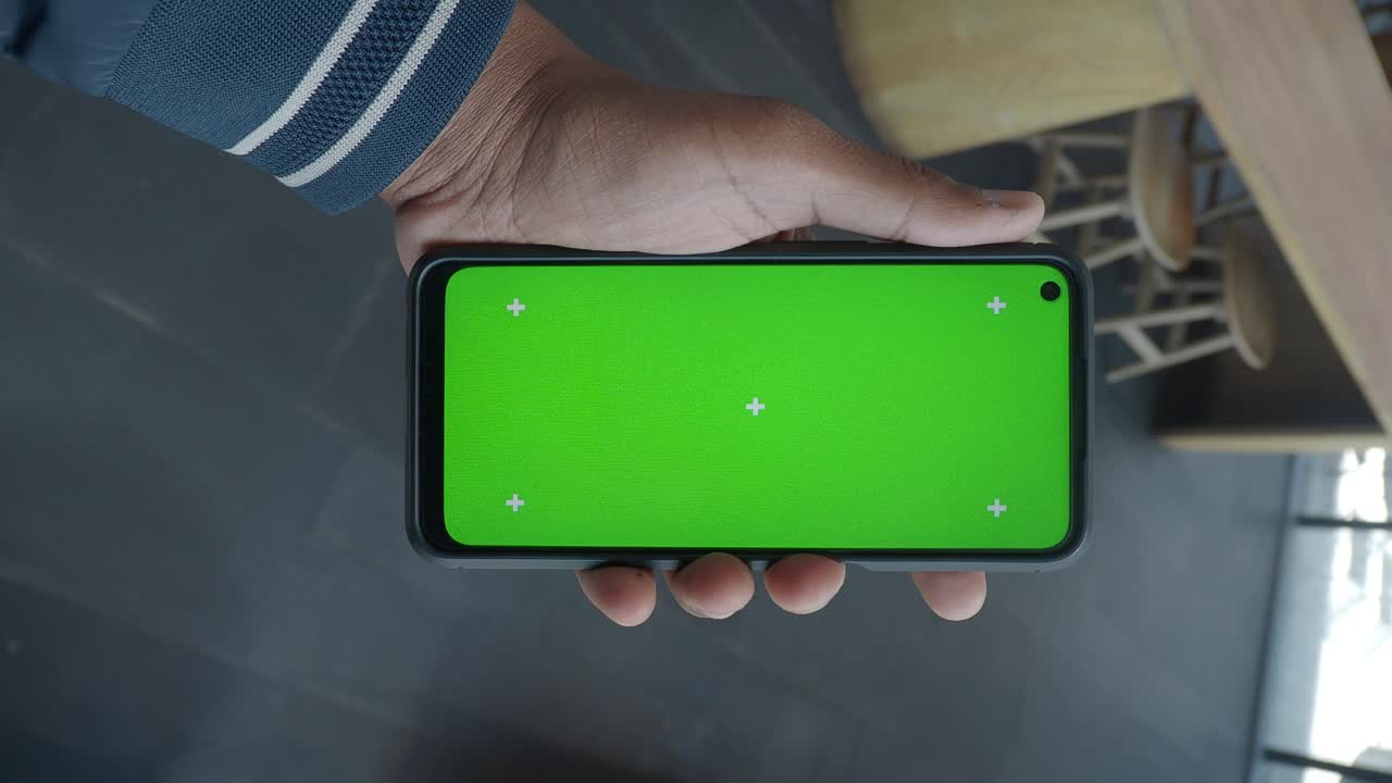 Smartphone with Green Screen Mockup Held in Hand