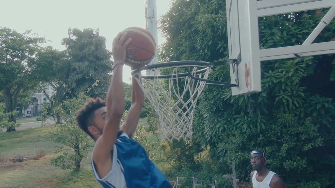 Young Man Scoring during Outdoor Basketball Game