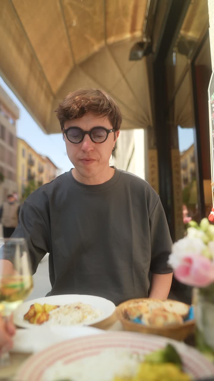 Person enjoying a meal at an outdoor cafe
