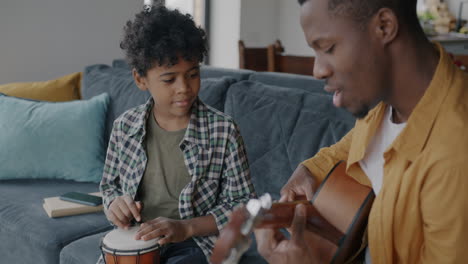 father and son learning music together