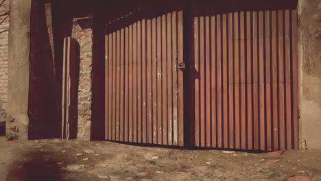 a closed, rusty wooden door to a garage