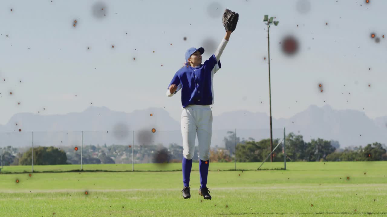 Outfielder looking up and raising glove to catch fly ball activating orange-red particles in sports