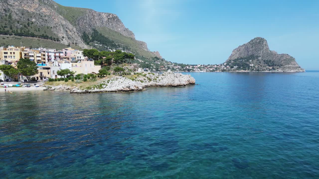 Aerial drone footage of Sant’Elia cove in Sicily: turquoise sea, rocky coastline, hidden beach, and Mediterranean charm. Perfect for travel, nature, and summer holiday projects