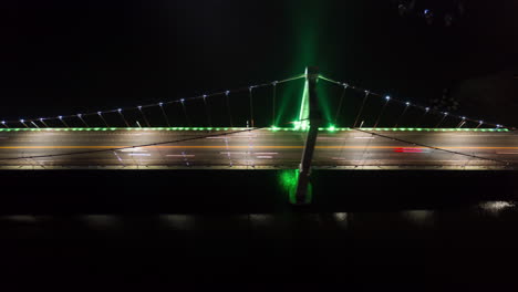 aerial time lapse of rush hour traffic over suspension bridge illuminated with neon lights - hyper lapse