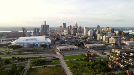 aerial backwards shot, downtown detroit with comercia baseball park and ford football indoor field