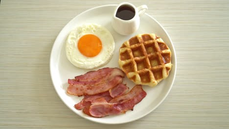 fried egg with bacon and waffle for breakfast