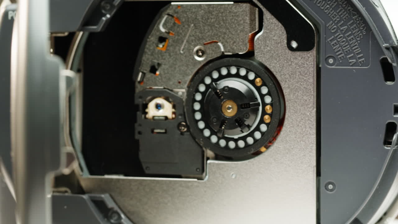 Vintage video-camera with disk inside rotating on black background close-up. Using portable camcorder to shooting videos