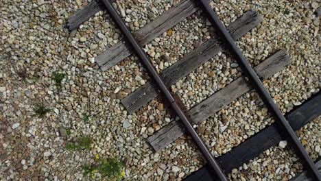 as the drone gracefully ascends, it offers a panoramic view of the railroad