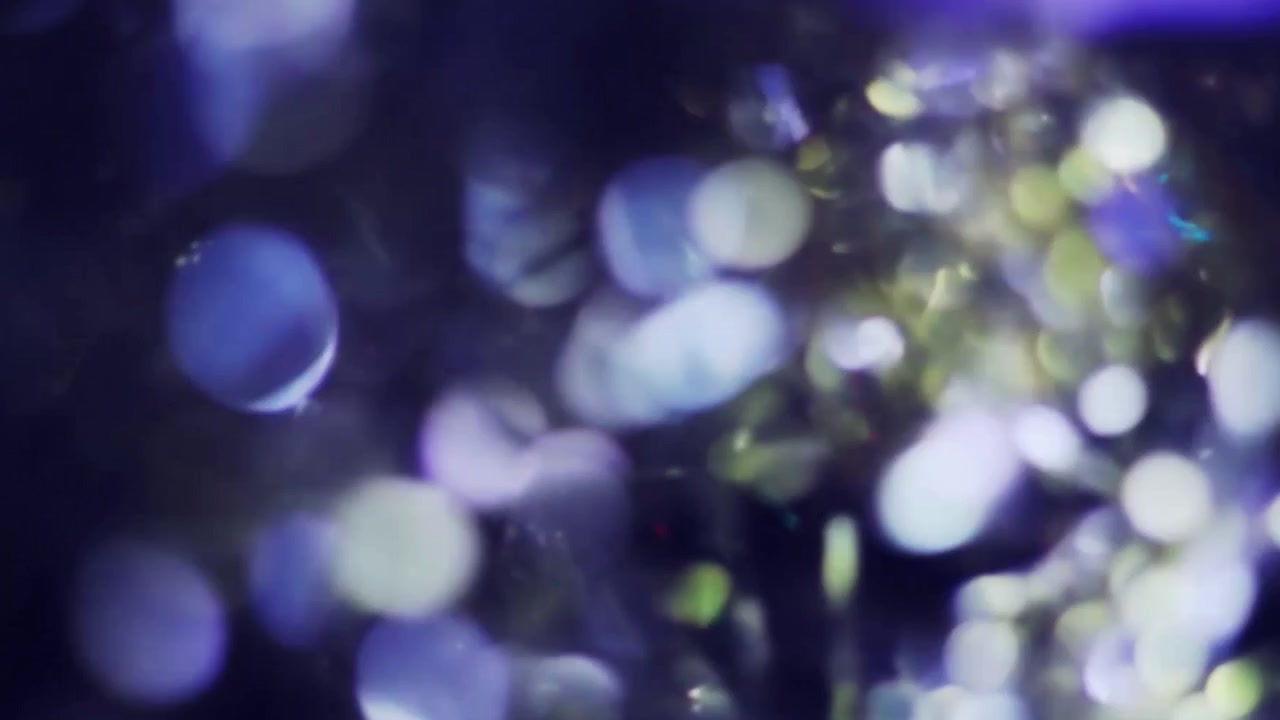 Sfondo astratto con bokeh di luce scintillante e particelle luccicanti