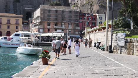 people walking by the sea in sorrento