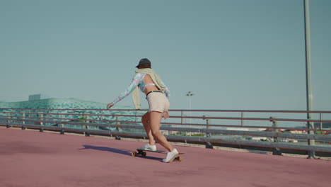 woman skateboarding on a city bridge