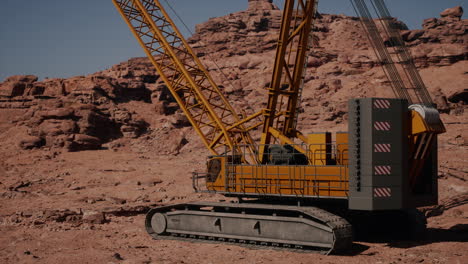 a yellow crawler crane in a desert setting