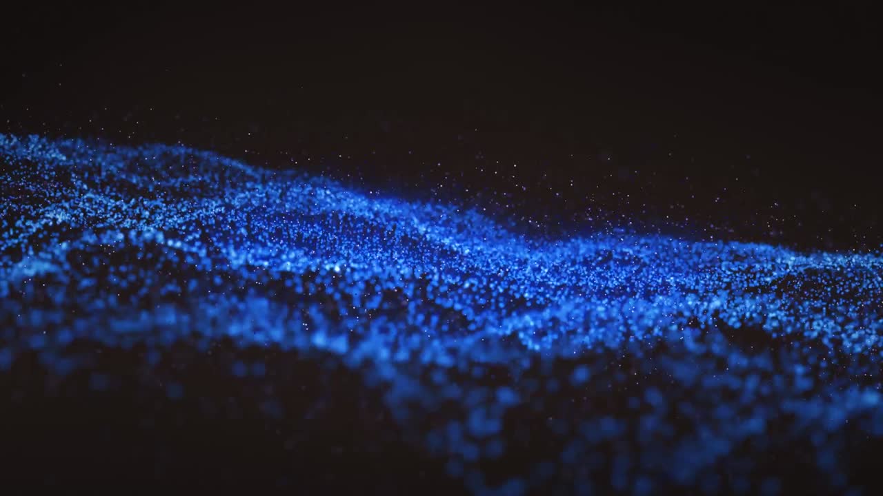 Animation of blue wave of spots on black background