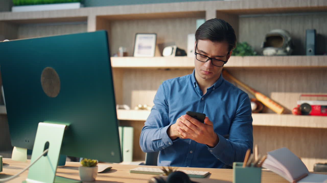 Happy startuper speaking smartphone office. Successful freelancer ending call