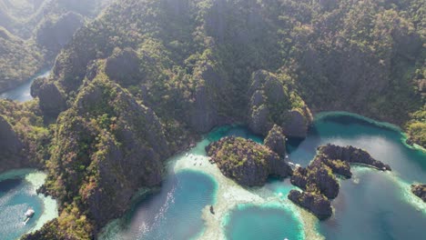 4k drone video of twin lagoon, the popular tourist spot near coron in palawan, philippines. the drone pans up to reveal the stunning mountains and islands in this part of palawan.