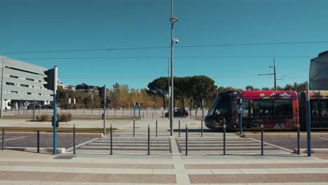 a colorful tram moving towards the city center, montpellier - france