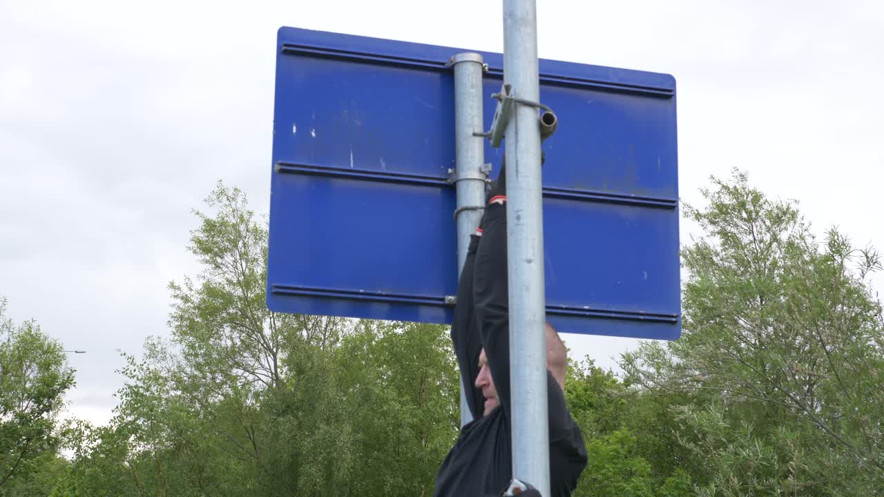 Handsome Caucasian Man Doing Pull-Ups On His DIY Bar Outdoors - Muscle Fitness Wellness Concept - medium shot