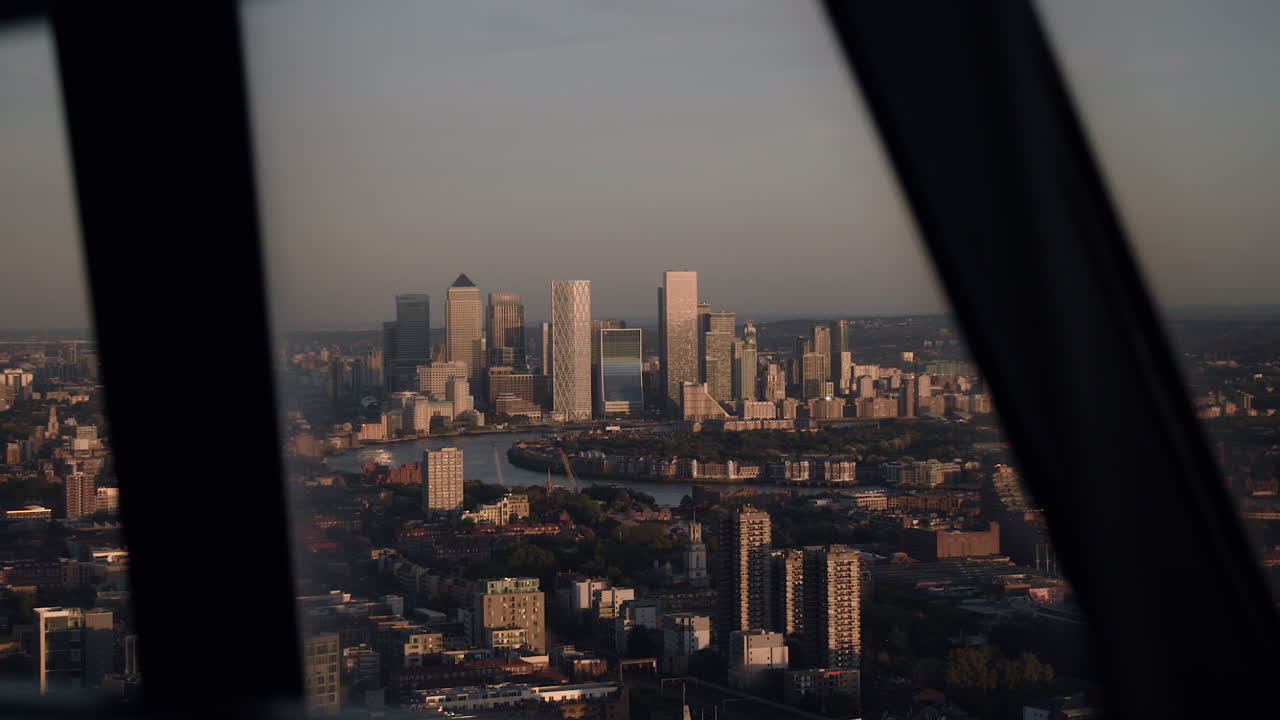 Canary Wharf seen through a window at dusk