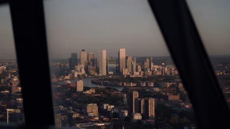 canary wharf seen through a window at dusk