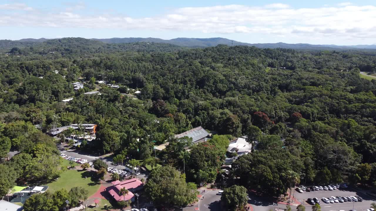 4K Aerial view of a small village surrounded by a tropical rainforest in North Queensland, Australia