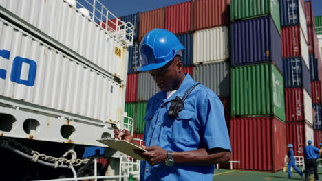 maritime worker inspecting cargo on a container ship