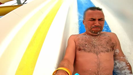 Man having fun in a water park. Slow motion
