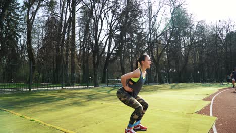 sports girl is training at the stadium. beautiful girl doing exercises. healthy sports lifestyle