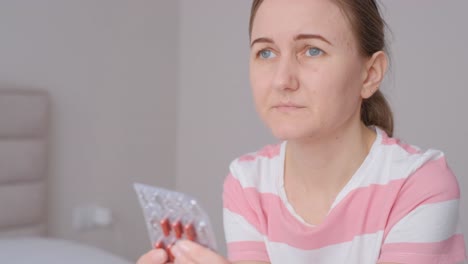 woman holding pills