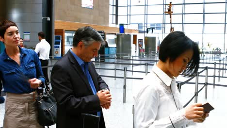 Commuters standing in queue for check-in