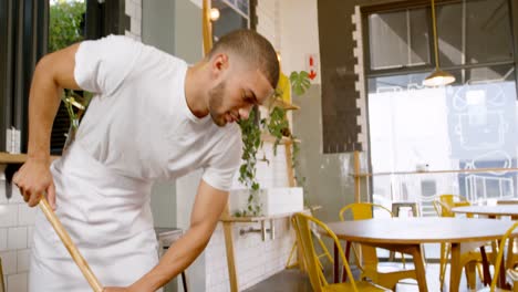 staff cleaning the floor in a cafe 4k