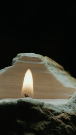 Burning Candle in a Stone Holder