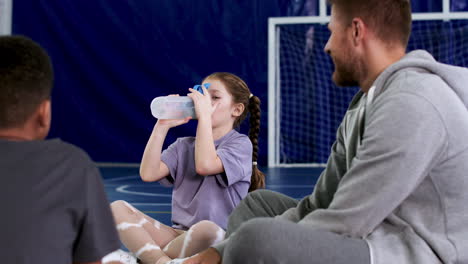 Man-and-children-sitting-on-the-floor