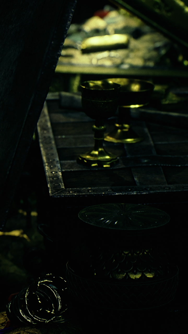Display of golden objects on a wooden table in a dark setting