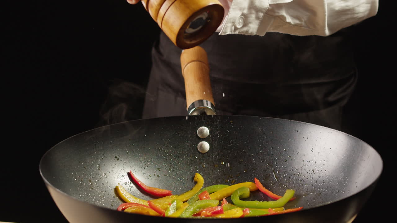 Chef Seasoning Stir-fried Peppers in Wok