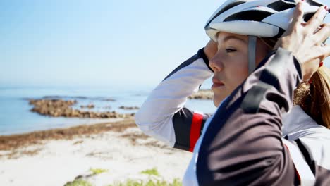 female cyclist wearing helmet in countryside 4k