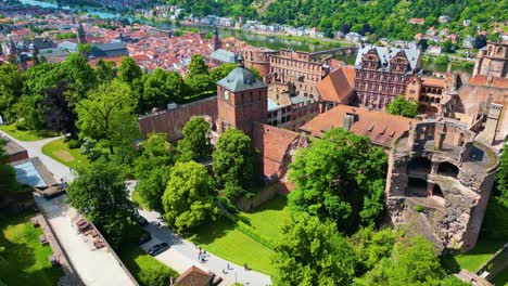 4k aerial drone video of ruins of historic castle on königstuhl hill overlooking heidelberg, germany