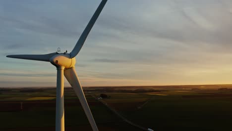 wind turbine at sunrise over agricultural fields