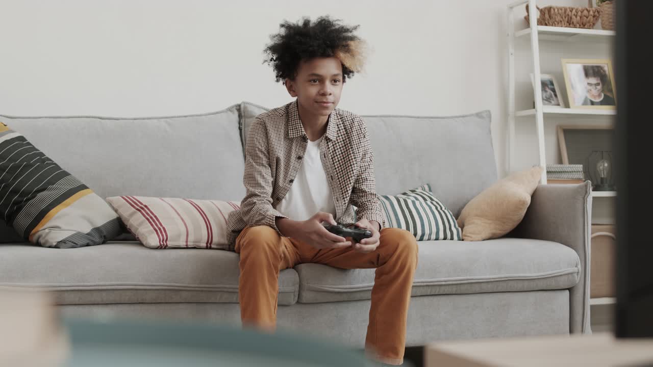 African Boy Playing on Game Console