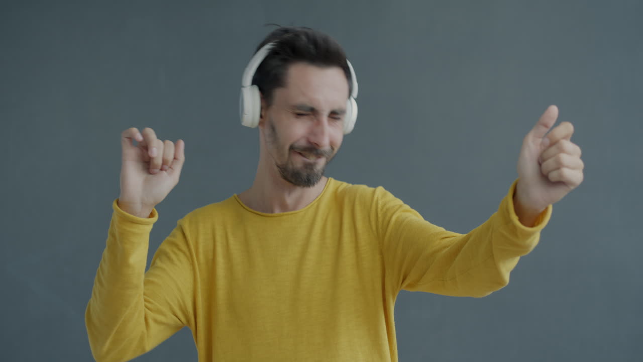 Man Dancing to Music with Headphones