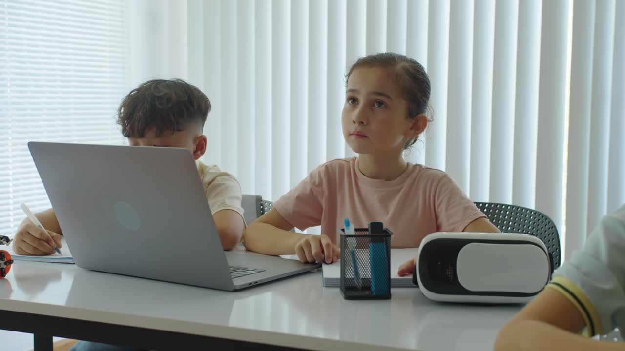 Little Girl Answering Teachers Question during Computer Class