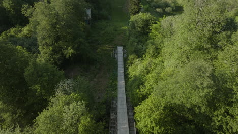 Abandoned-Ski-Jump-Covered-With-Lush-Foliage-Of-Trees-Near-Bakuriani-Mountains-In-Georgia