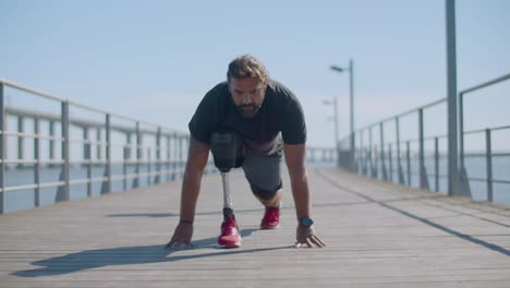 male athlete with disability doing stretching exercises.