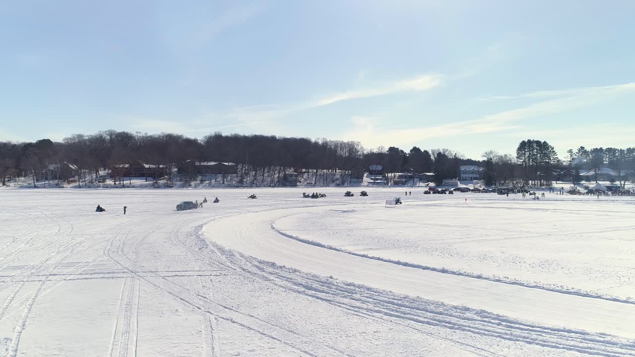 Dynamic view of UTVs racing around an icy course on a bright day