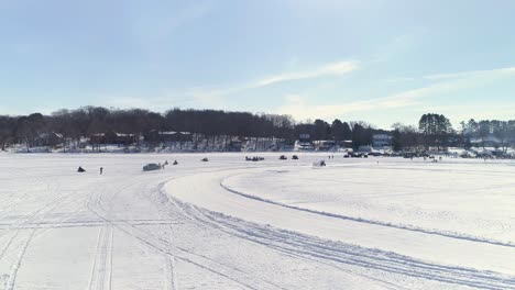 dynamic view of utvs racing around an icy course on a bright day
